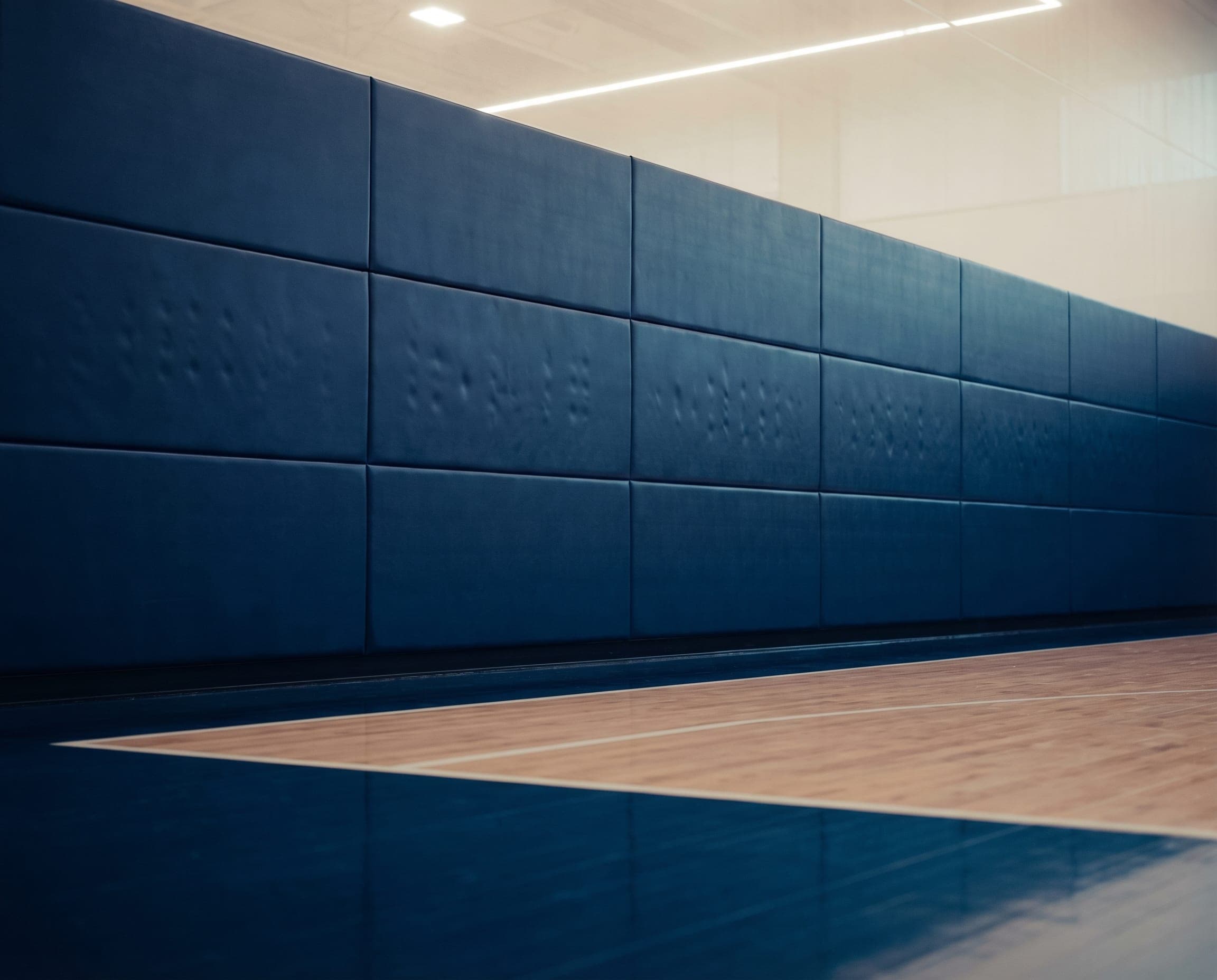 Ayana safety wall panels division — EN 14904 impact-resistant gymnasium wall protection in Qatar.